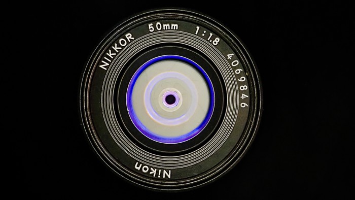 Front view of a Nikkor 50mm f/1.8 lens showing its aperture and front element. Front view of a Nikkor 50mm f/1.8 lens showing its aperture and front element.